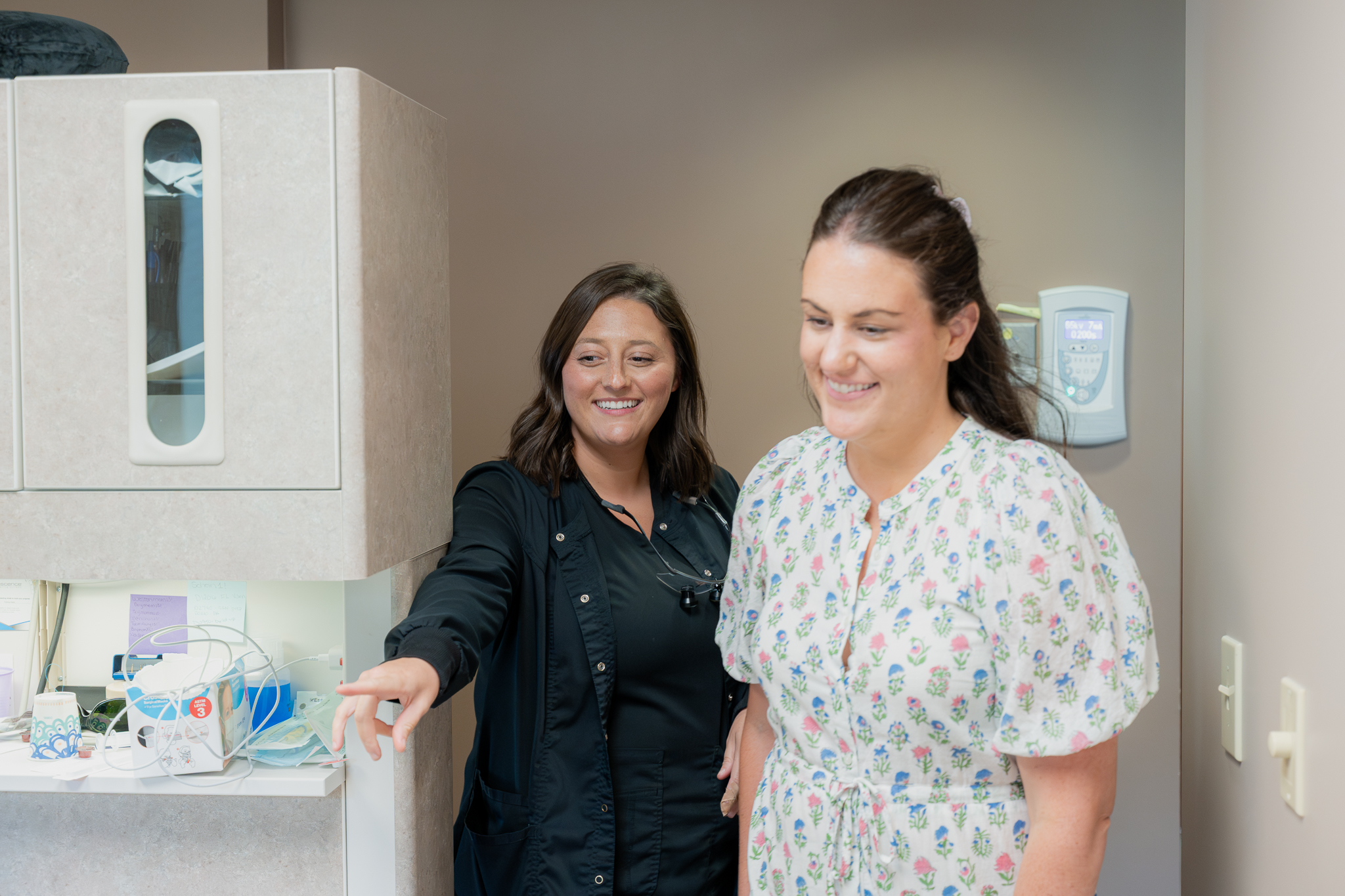 Dental team member showing a patient around the treatment room