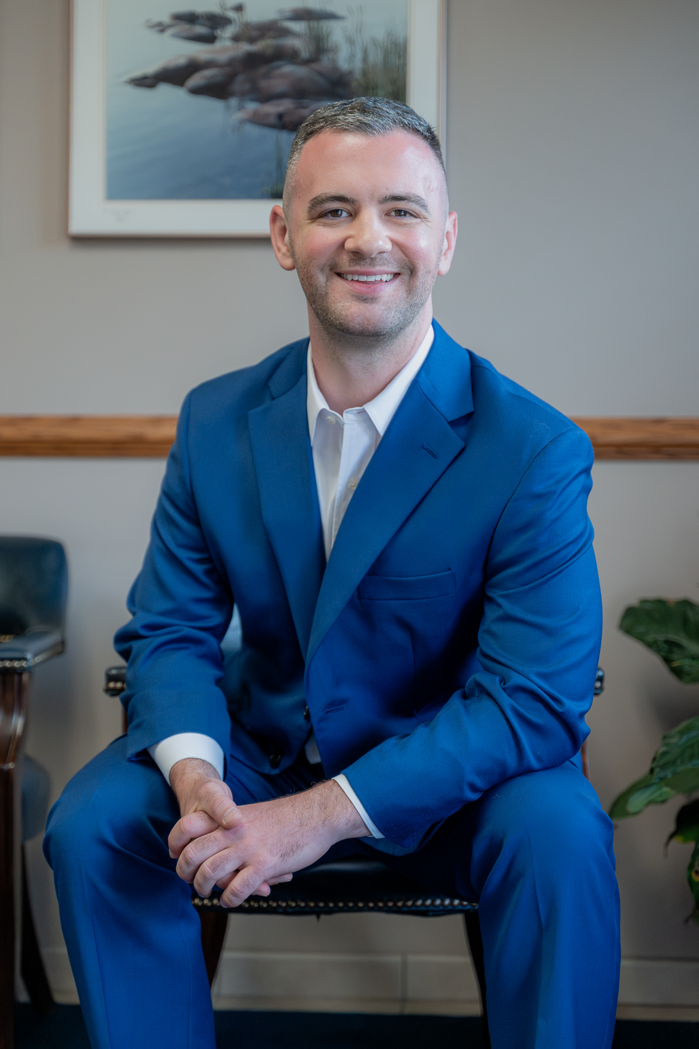 Dr. Thomas Rouse, DDS, in a blue suit seated in the waiting room
