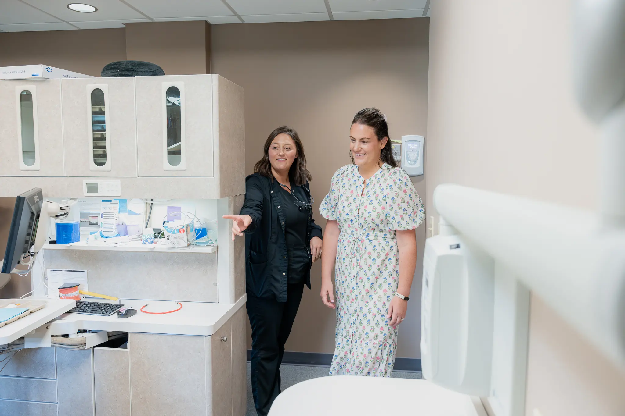 Team member showing a patient around a treatment room