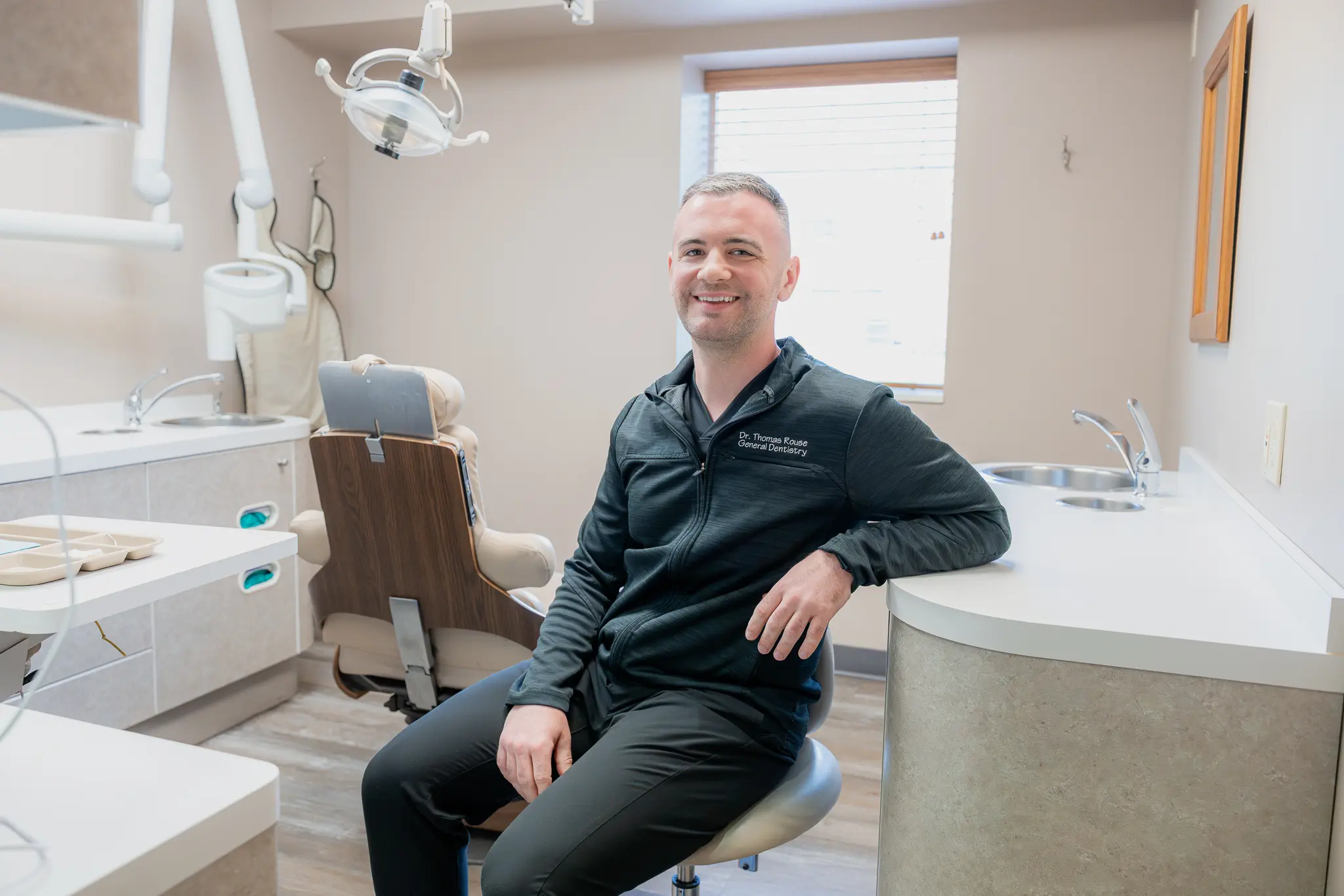 Dr. Thomas Rouse, DDS, seated in a treatment room at High + Henderson Dental